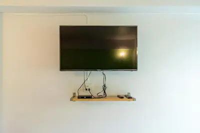 a flat screen tv hanging on a wall at Living Naraa Place in Bangkok