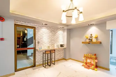 a kitchen with a brick wall at Living Naraa Place in Bangkok