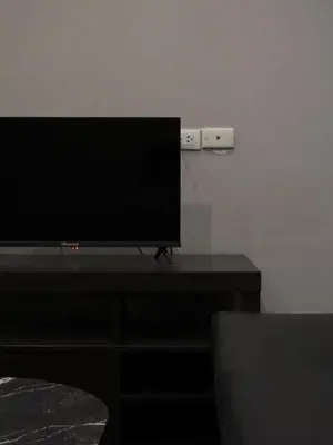 a flat screen tv sitting on top of a table at Teja Hotel in Bangkok