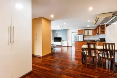 a kitchen and dining room with a table and chairs at Teja Hotel in Bangkok