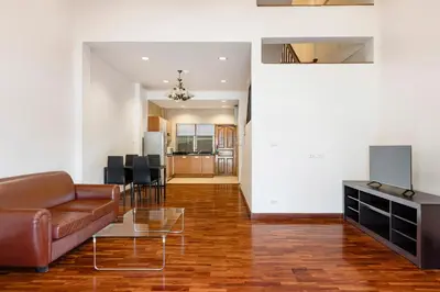 a living room with a couch and a table at Teja Hotel in Bangkok