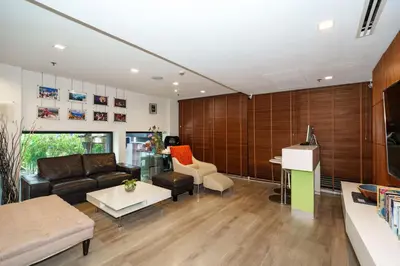 a living room with a couch and a table at Marvin Suites Hotel in Bangkok