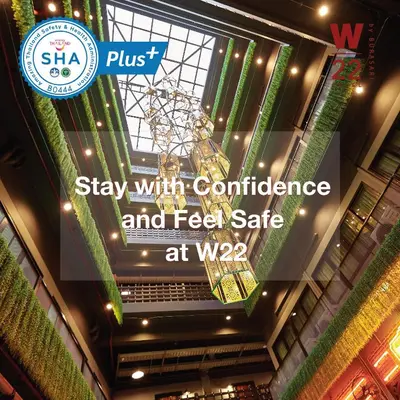 a sign hanging from the ceiling of a building at W22 by Burasari in Bangkok