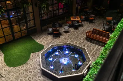 a room with a fountain in the middle of a building at W22 by Burasari in Bangkok
