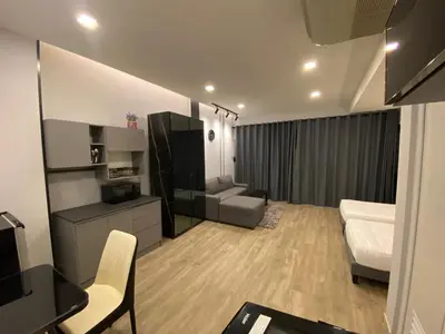a small living room with a bed and a couch at Bangyai Inn-private room in Nonthaburi