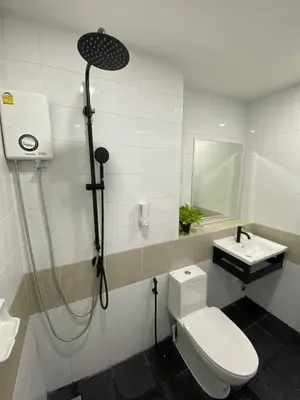 a bathroom with a shower and a toilet and a sink at Bangyai Inn-private room in Nonthaburi