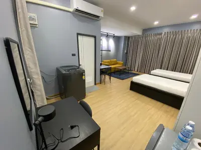 a hotel room with a bed and a desk and a table at Bangyai Inn-private room in Nonthaburi