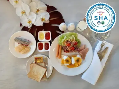 a table with two plates of food on a table at S Bangkok Hotel, Navamin in Ban Khi Sua