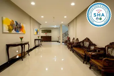 a lobby with chairs and a sign on the wall at S Bangkok Hotel, Navamin in Ban Khi Sua
