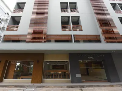 an external view of a building with tables and chairs at Grand Watergate Hotel in Bangkok