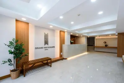 a lobby with a bench in the middle of a building at Grand Watergate Hotel in Bangkok