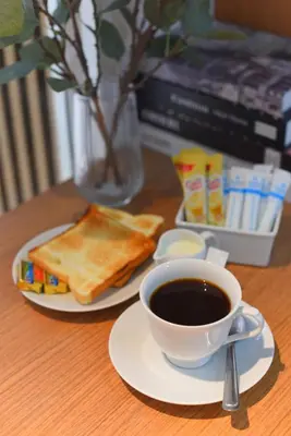 a cup of coffee and toast on a table at Grand Watergate Hotel in Bangkok