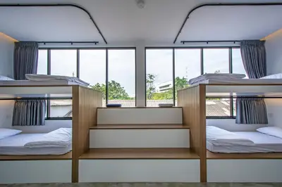 two bunk beds in a room with windows at Lost Inn BKK in Bangkok