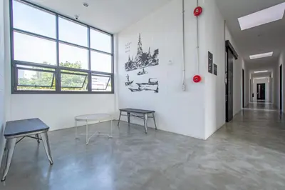 a white room with two tables and chairs in it at Lost Inn BKK in Bangkok