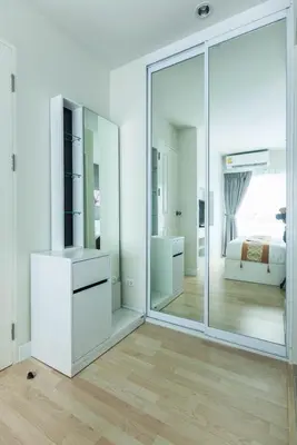 a white bedroom with a mirror and a bed at The Cube Residence Government Complex Laksi in Lak Si