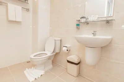 a bathroom with a toilet and a sink at The Cube Residence Government Complex Laksi in Lak Si