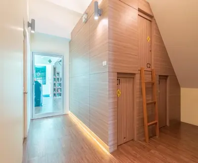 a room with a wooden wall and a staircase at The Victory View in Bangkok