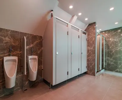 a bathroom with two urinals and stalls in it at The Victory View in Bangkok