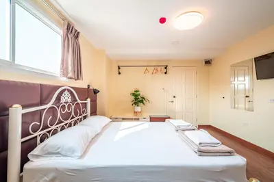 a bedroom with a large bed with a large window at The Victory View in Bangkok