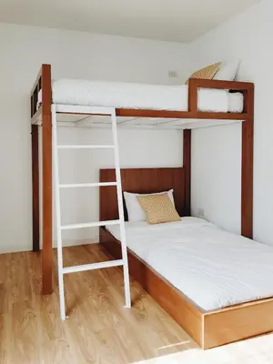 a bunk bed with a ladder and a bunk bed frame at LITA Bangkok in Bangkok