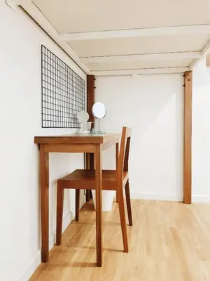 a wooden table with a chair and a mirror on it at LITA Bangkok in Bangkok