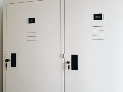 two white doors with numbers on them in a room at LITA Bangkok in Bangkok