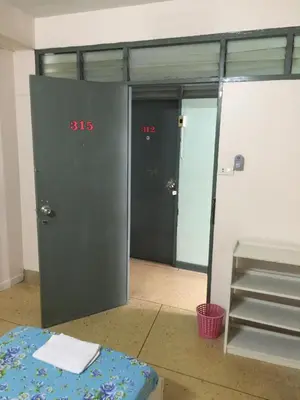 a room with two doors and a table in a room at NAT 2 Guest House in Bangkok