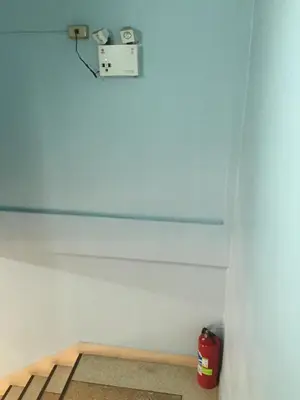 a room with a white wall with a camera on it at NAT 2 Guest House in Bangkok