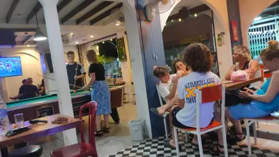a group of people sitting in a restaurant at NAT 2 Guest House in Bangkok