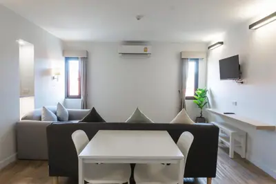 a living room with a couch and a table at Carnation Residence in Samut Prakan
