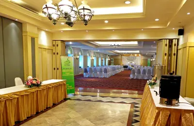 a banquet hall with white chairs and tables in a room at Iyarin @ Tuk Chang Hotel in Bangkok