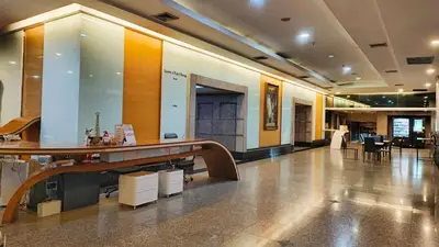 a lobby with a table and chairs in a building at Iyarin @ Tuk Chang Hotel in Bangkok