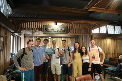 a group of people posing for a picture in a room at Suneta Hostel Khaosan in Bangkok