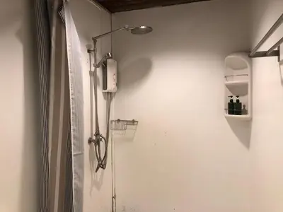 a shower in a bathroom with a shower at Suneta Hostel Khaosan in Bangkok