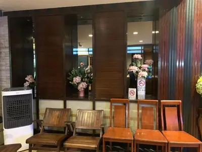 a group of chairs sitting in a room with flowers at Rambuttri House in Bangkok