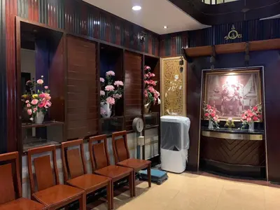 a waiting room with chairs and flowers on the wall at Rambuttri House in Bangkok