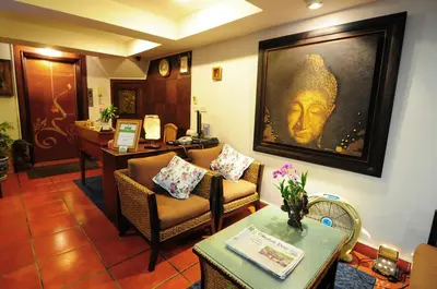 a living room with a portrait of a man on the wall at Baan Sukhumvit Soi 20 in Bangkok