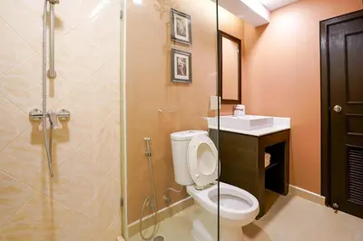 a bathroom with a shower and a toilet and a sink at Baan Sukhumvit Soi 20 in Bangkok