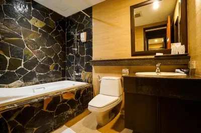 a bathroom with a toilet and a sink and a tub at Baan Sukhumvit Soi 18 in Bangkok