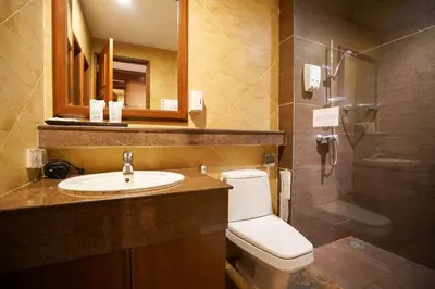 a bathroom with a toilet and a sink and a shower at Baan Sukhumvit Soi 18 in Bangkok