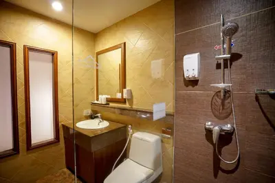 a bathroom with a shower and a toilet and a sink at Baan Sukhumvit Soi 18 in Bangkok