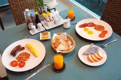 two plates of breakfast food on a table at Baan Sukhumvit Soi 18 in Bangkok