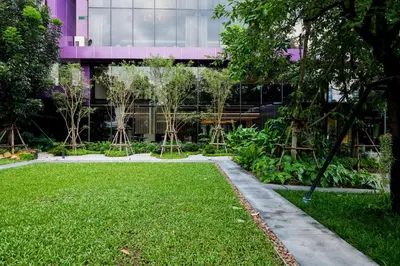 a garden in front of a building at TK Palace Hotel & Convention Bangkok in Bangkok