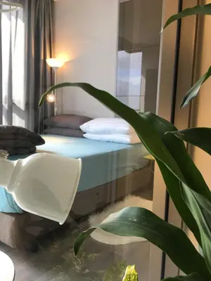 a bedroom with a bed and a plant next to a window at Bangkok view,Luxurious 1 Bedroom Sathon in Bangkok