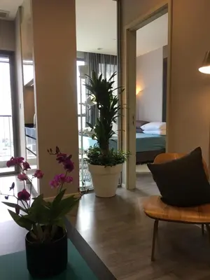 a living room with potted plants and a bedroom at Bangkok view,Luxurious 1 Bedroom Sathon in Bangkok