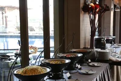 a buffet with bowls of food on a table at Riva Surya Bangkok in Bangkok