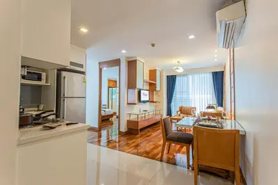 a kitchen and living room with a table and a dining room at D Varee Montara Thonglor 25 in Bangkok