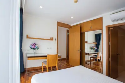 a bedroom with a bed and a table and chairs at D Varee Montara Thonglor 25 in Bangkok