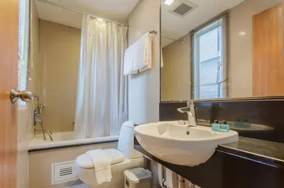 a bathroom with a sink and a toilet and a mirror at D Varee Montara Thonglor 25 in Bangkok