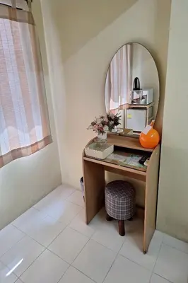 a vanity with a mirror and a desk in a room at MS Mansion in Bangkok